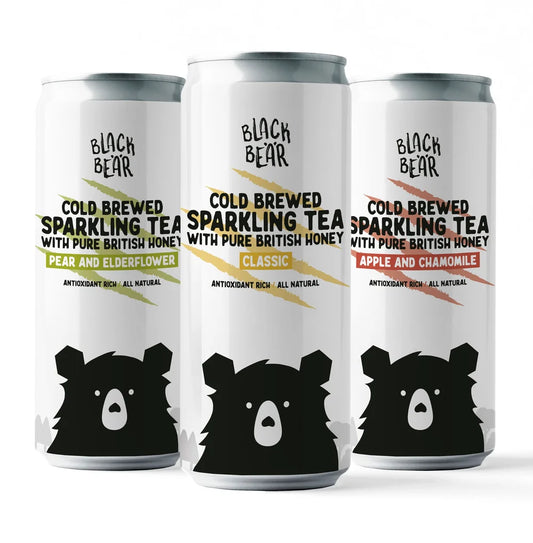 Three cans of Black Bear Honey Co. Tea. Classic pure honey, pear and elderflower, and apple and chamomile.
