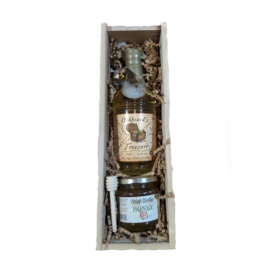 An open gift box containing a 500ml bottle of oak aged mead, an 8oz jar of Hampshire Honey, and a honey dipper.