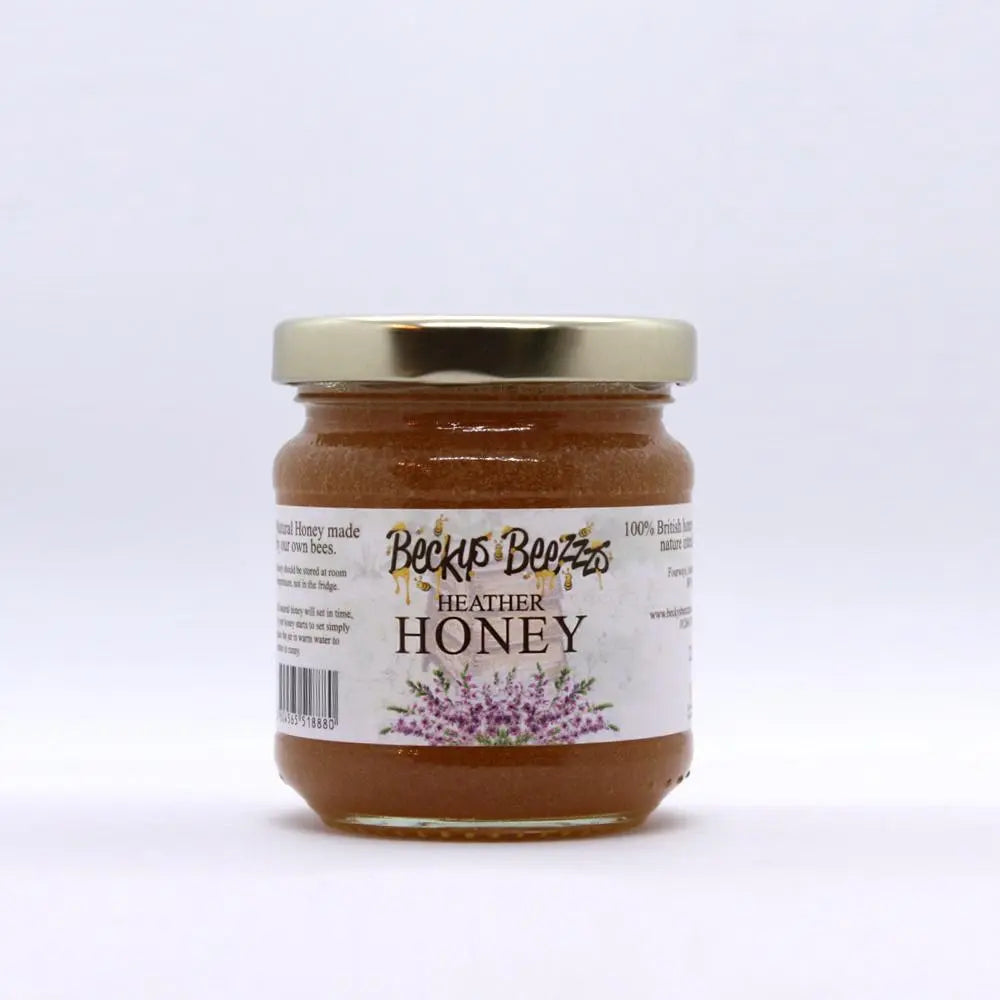 Jar of Heather Honey with a gold lid on a white background