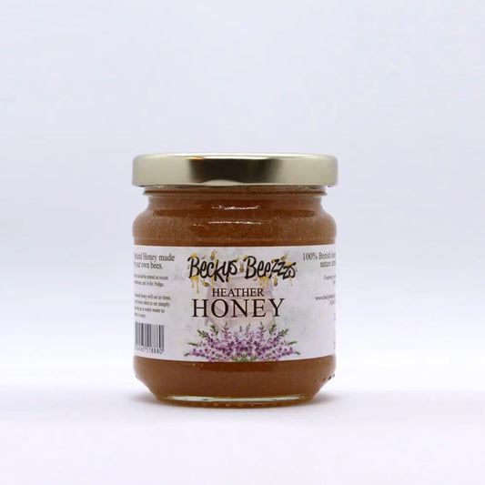 Jar of Heather Honey with a gold lid on a white background
